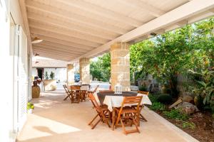 a patio with a table and chairs on it at santa potenza in Felline