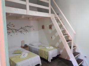 a room with two beds and a staircase at Pousada Veadeiros - Alto Paraiso de Goiás in Alto Paraíso de Goiás