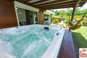 a hot tub in the backyard of a house at La COOL & DOUCE - Villa COOL in Le Gosier