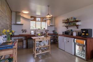 
a kitchen filled with furniture and a stove at Skyrhúsid Guest House in Hali
