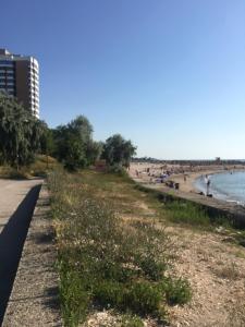 a sandy beach with people on the beach at IOANA - camere de inchiriat in Mangalia +22 photos