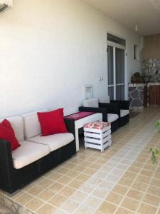 a living room with a couch and a table at Apartmani Dini in Ulcinj
