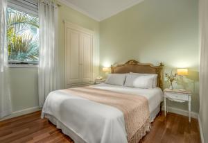 a bedroom with a large white bed and a window at 248 Finisterra in Buenos Aires