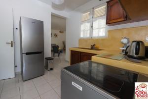 a kitchen with a refrigerator and a counter top at Kouleur Karayib in Le Gosier