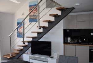 a staircase in a living room with a tv at Marlin Apartments in Dubrovnik
