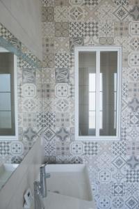 a bathroom with a sink and a mirror at Villa Clarisse in Deauville