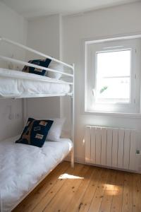a bedroom with a bunk bed and a window at Villa Clarisse in Deauville