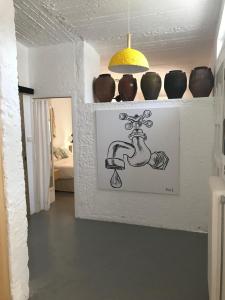 a bathroom with a drawing of a faucet on the wall at Manolis' House in Skiathos Town