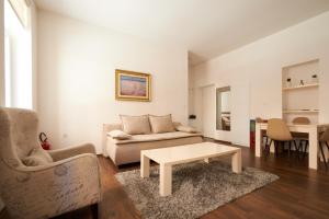 a living room with a couch and a coffee table at Central Inn Apartments Sarajevo in Sarajevo