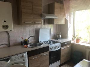 a kitchen with a sink and a stove top oven at Здається квартира подобово in Kamianets-Podilskyi