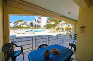 a balcony with a table and a view of the beach at BEACH house in Sesimbra