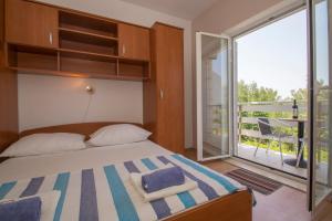 Posteľ alebo postele v izbe v ubytovaní Vita Apartments