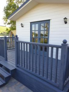 a deck with a blue fence and a house at The Cranagh in Coleraine +41 photos