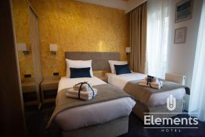 Łóżko lub łóżka w pokoju w obiekcie Hotel Elements