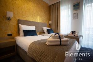 Łóżko lub łóżka w pokoju w obiekcie Hotel Elements