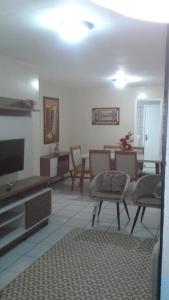 - un salon avec une télévision, une table et des chaises dans l'établissement Apto próximo ao Centro de Eventos e OAB-CE, à Fortaleza