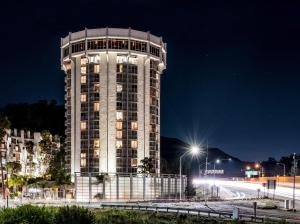 a tall building with lights on it at night at Hotel Angeleno in Los Angeles