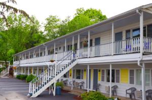 a large building with white balconies and stairs at Admiral Motel in Lake George