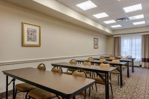 a classroom with tables and chairs in a room at Comfort Inn & Suites Fort Myers Airport in Fort Myers