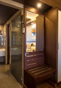 a door leading into a room with a bedroom at KPM TRIPENTA HOTEL in Kozhikode