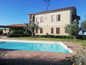 a house with a swimming pool in front of a building at Il Casale degli Ulivi - Agriturismo - TENIMENTI LEONE in Lanuvio