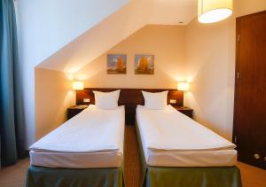 Łóżko lub łóżka w pokoju w obiekcie Hotel Nowodwory
