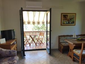 a living room with a sliding glass door to a patio at Vila Kajče in Omišalj +24 photos
