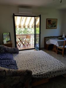 a bedroom with a bed and a sliding glass door at Vila Kajče in Omišalj