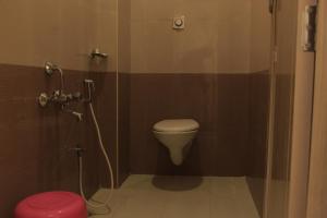 a bathroom with a toilet and a shower stall at Sri Sarvesha Residency Temple view in Tiruvannāmalai