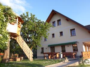 a house with a wooden staircase in front of it at Boutique Hotel Loka in Škofja Loka