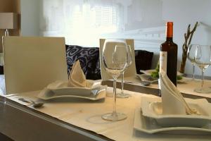 a table with a bottle of wine and glasses on it at Apartamento en Blanes con piscina y parking in Blanes
