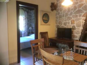 a dining room with a table and a bedroom at Ktima Nafsika - First-floor luxury apartment in majestic estate in Rozaíika