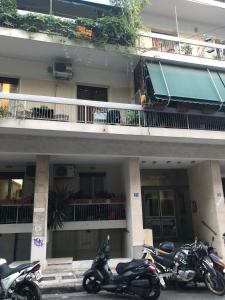 two motorcycles parked in front of a building at Anna Apartment in Kypseli in Athens