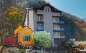 a building with a car parked in front of it at 5 Star Residence in Braşov