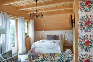 a bedroom with a bed and a wooden ceiling at Gorce Oasis in Szlembark