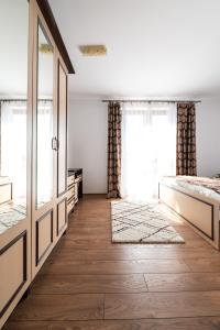 a room with two beds and a large window at La Tusa Dusa in Ocolişu Mic +17 photos