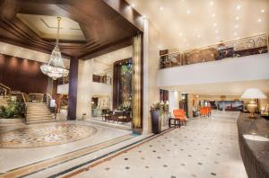 a lobby of a hotel with a staircase and a building at Pyramisa Suites Hotel Cairo in Cairo