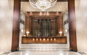 a rendering of a lobby with a chandelier at Pyramisa Suites Hotel Cairo in Cairo