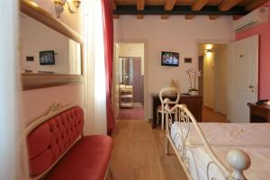 a bedroom with a bed and a living room with a table at Locanda Al Ponte de Fero in Jesolo