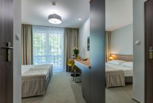 Postel nebo postele na pokoji v ubytování Hotel Zorza + 37 fotografií
