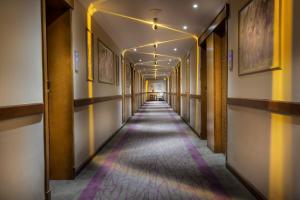 a long hallway with yellow and purple lines on the walls at Pyramisa Suites Hotel Cairo in Cairo