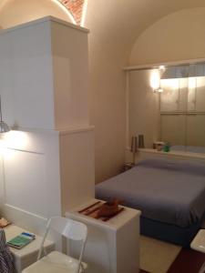 a bedroom with a bed and a table and chairs at A little gem in the old city center... in Lerici