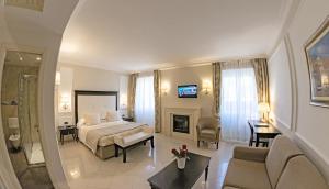 a bedroom with a bed and a living room at Hotel Miramare & Spa in Sestri Levante