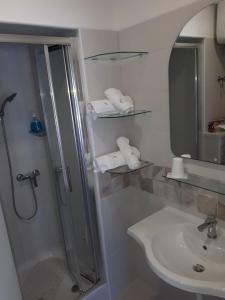 a bathroom with a shower and a sink at Studio Udica in Podgora +25 photos