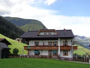 a house on a hill with mountains in the background at Haus Edring in Tux