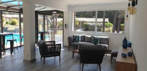 a living room with a couch and chairs and a table at Prea Gianca in Bonifacio