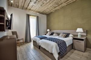 Postel nebo postele na pokoji v ubytování Cozy Rooms Hotel