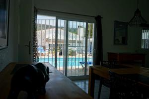 ein Esszimmer mit einer Glasschiebetür zum Pool in der Unterkunft Sea près des Golfs in Santa Cristina d'Aro