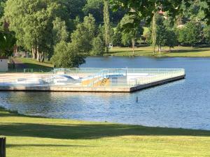 a dock on a lake with boats on it at Chambre privative in Saint-Rémy-sur-Durolle