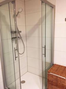 a shower with a glass door in a bathroom at Ferienwohnung (70 qm) mit fantastischem Ausblick in Detmold
